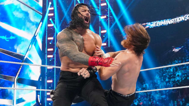 Roman Reigns hits Sami Zayn with a shoulder tackle